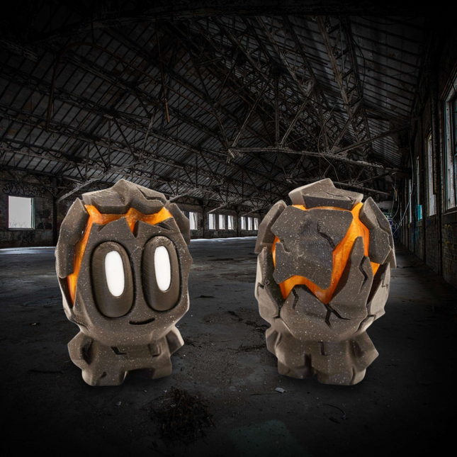 Two stone-like characters with orange accents in an abandoned warehouse setting