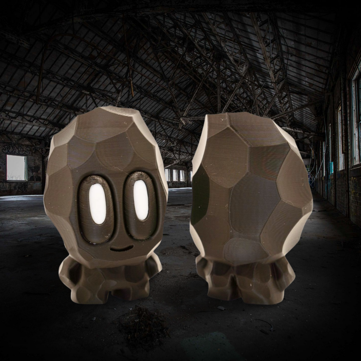 Two large stone-like sculptures with facial features in a dark, abandoned building.