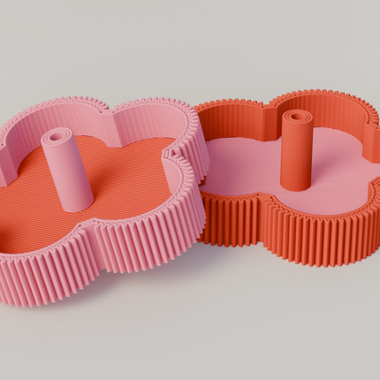 Two flower-shaped incense holders, one pink and one red, on a light gray background.